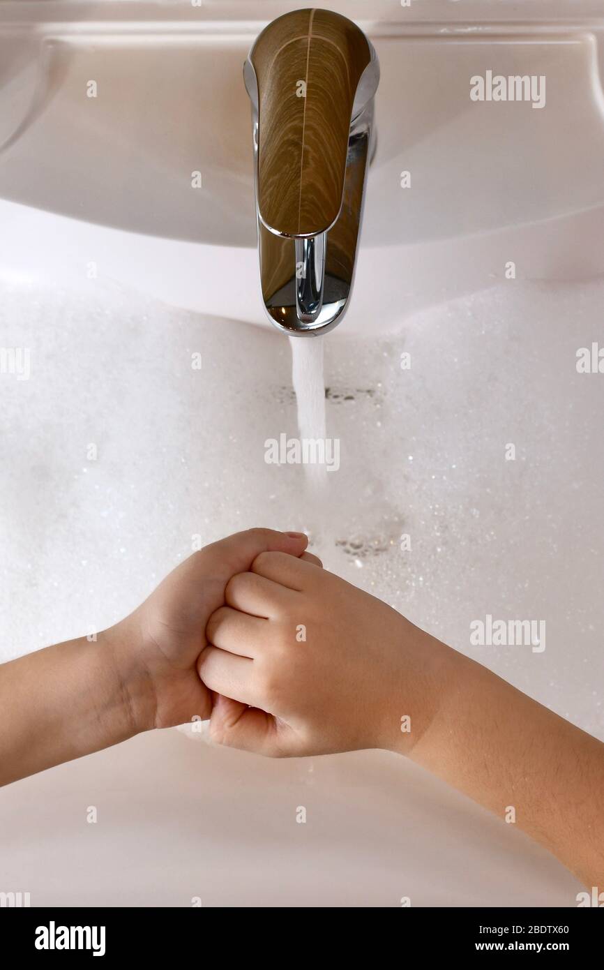 The child learns to wash the inside of the fist, fingertips and nail zone  with water in the sink Stock Photo - Alamy