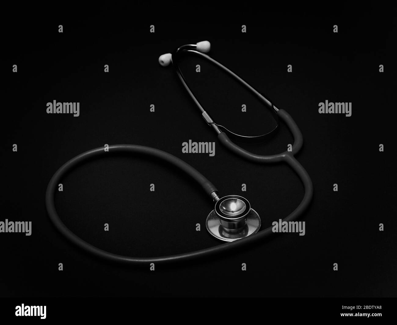 Stethoscope - a medical instrument for listening to the action of someone's heart or breathing, typically having a small disc-shaped resonator that is Stock Photo