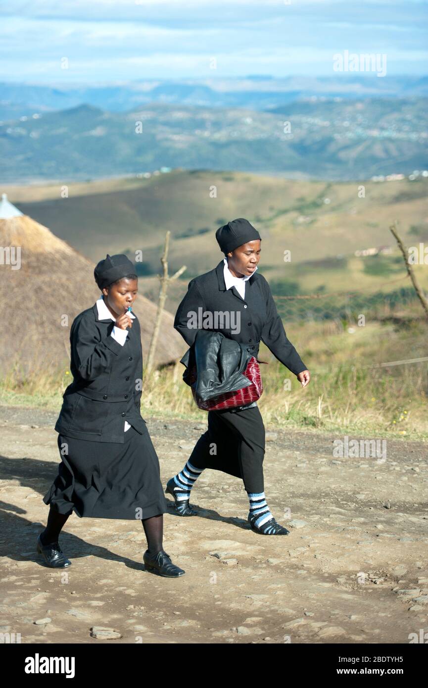 Schoolgirls in uniform walking by scenic view, Pondoland, Eastern Cape, Transkei, South Africa Stock Photo