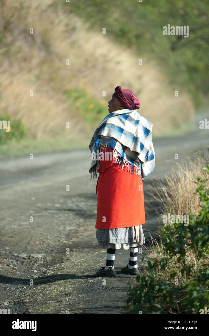 Woman wearing rug on path, Pondoland, Eastern Cape, Transkei, South Africa Stock Photo