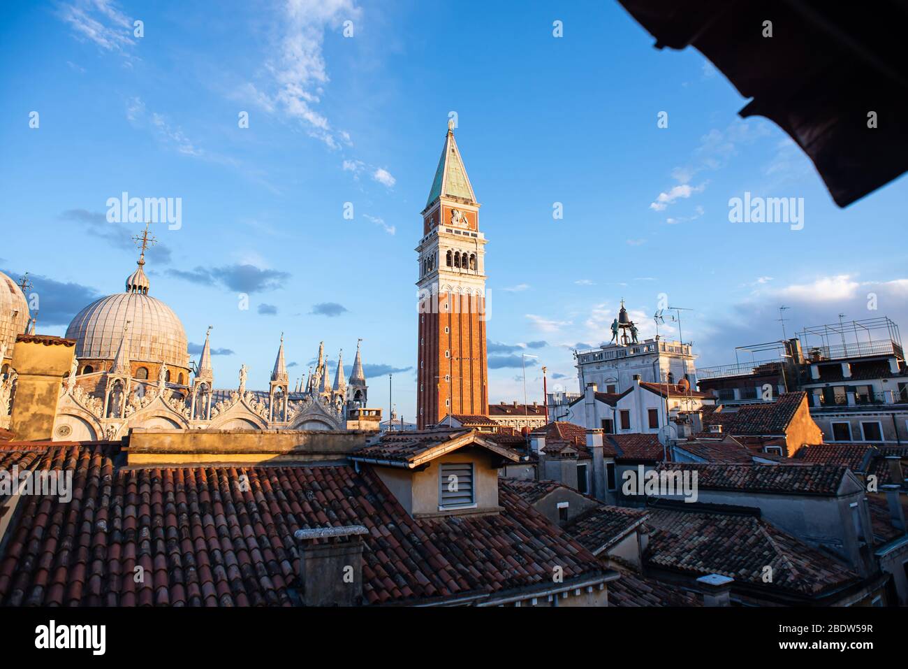 Basilica of Saint Mark and Bell Tower of St Mark's Campanile (Campanile di San Marco) in Venice, Italy. Sunrise. View from Window. Stock Photo