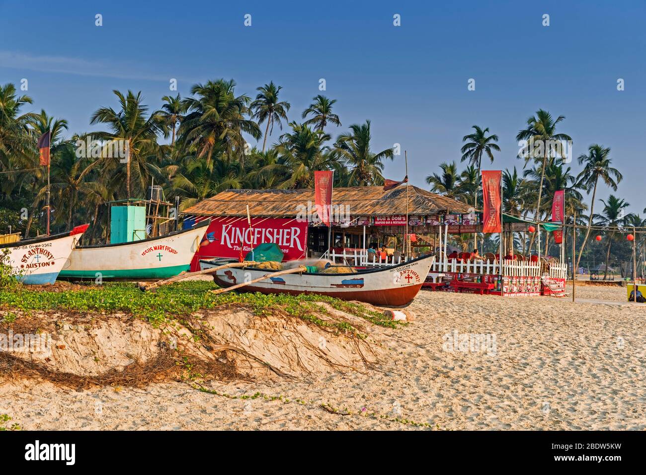 Fishing boats and beach hut café Colva Goa India Stock Photo