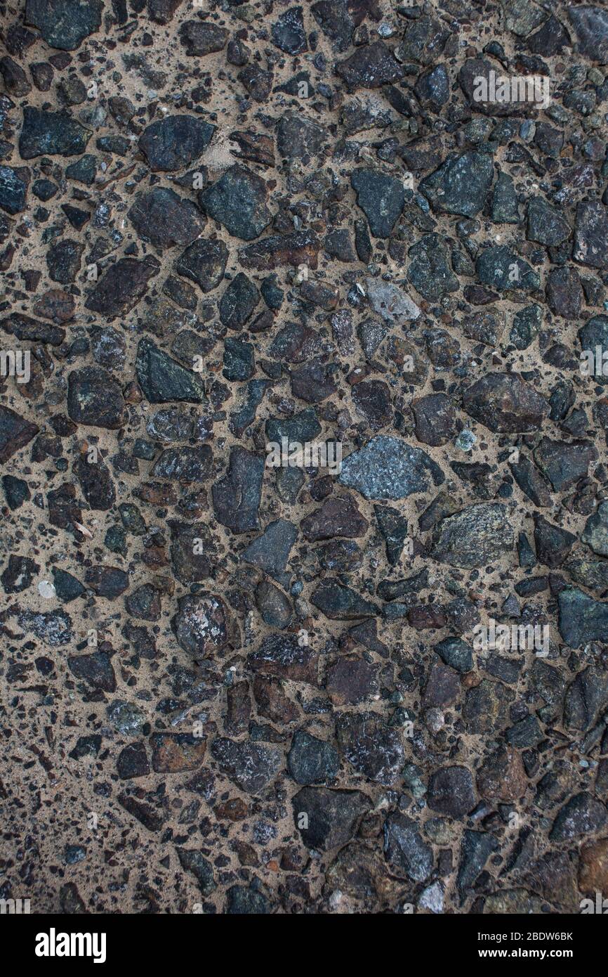 Sea sand with remnants of shells and small pebbles. Background. Stock Photo