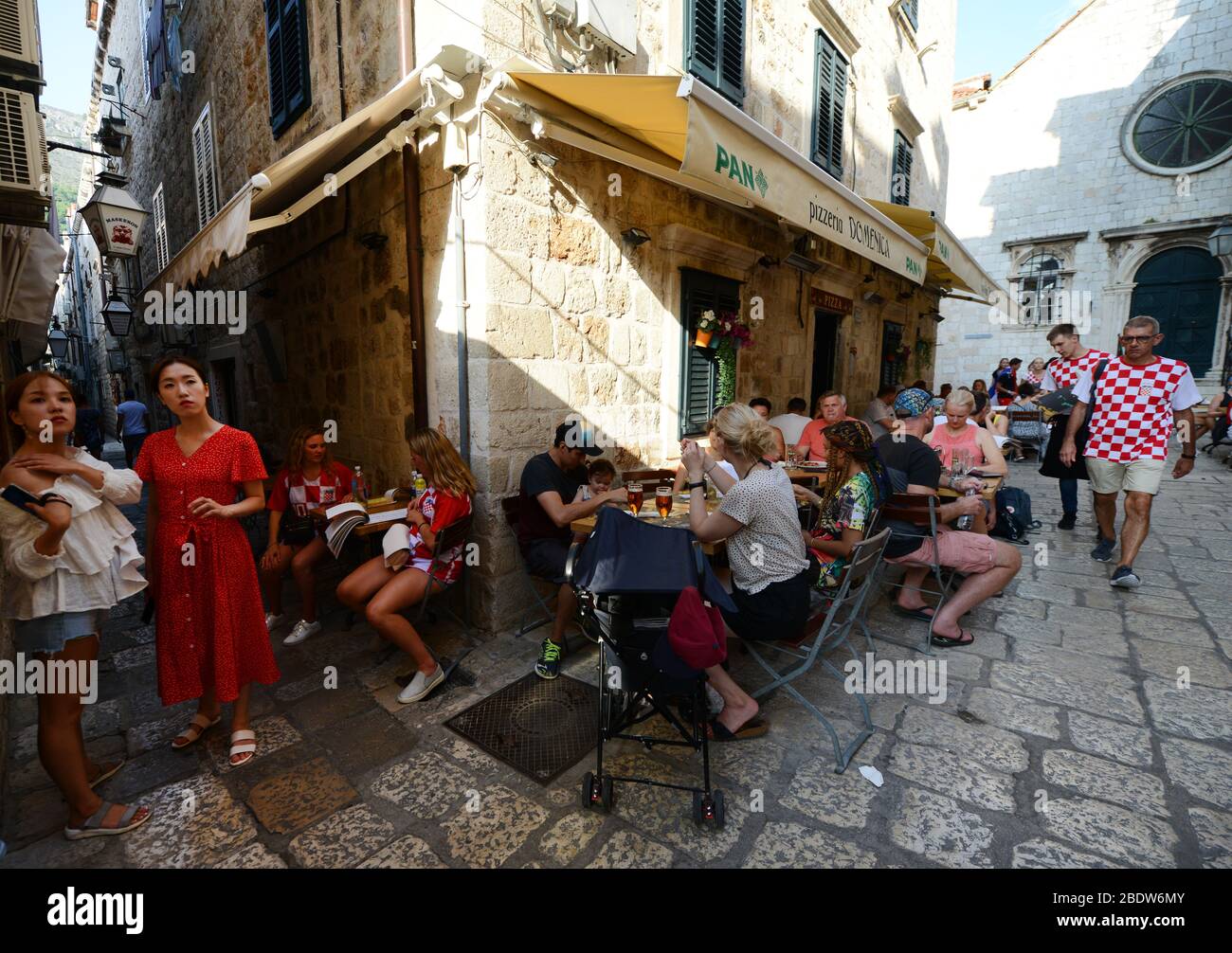 cafes and restaurants in the narrow streets of Dubrovnik's old town. Stock Photo