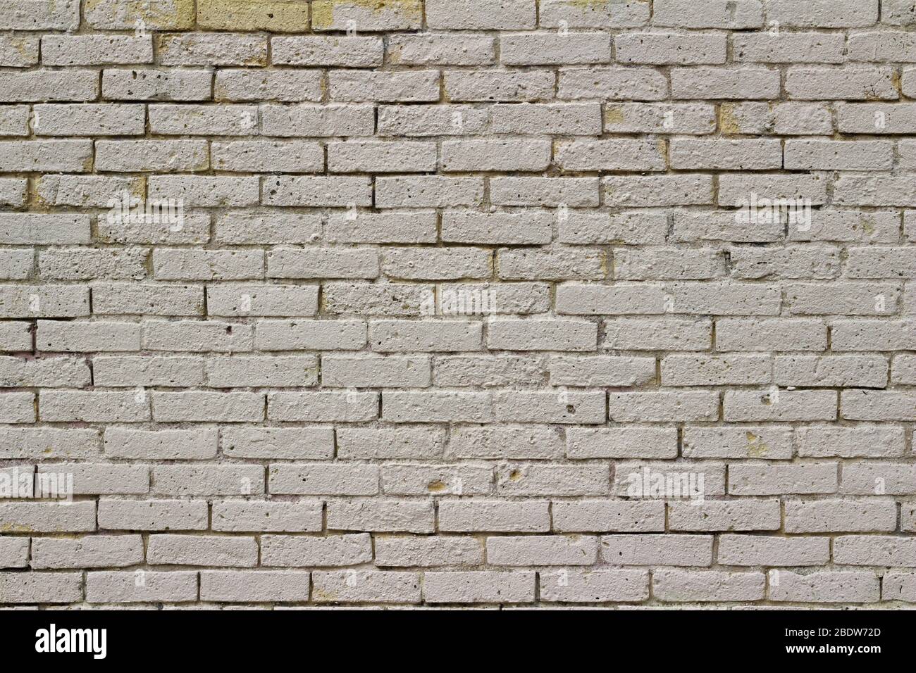 Shabby chic old yellow brick wall texture background, showing a pitted ...