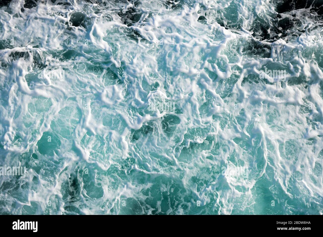 Ocean water abstract background. Sea bubbling water texture closeup Stock Photo