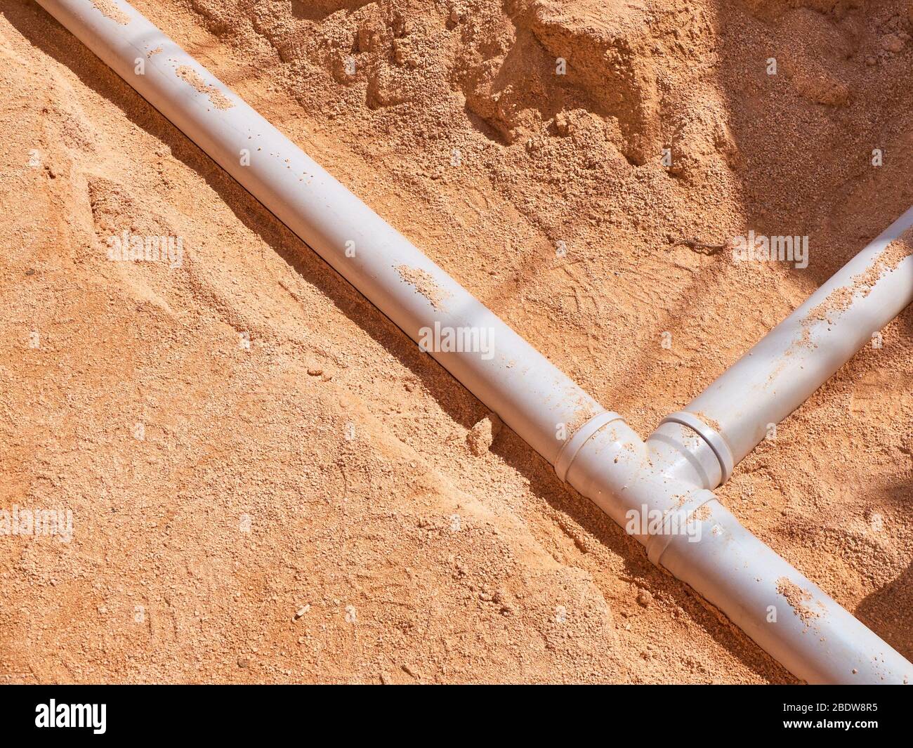 Junction of plastic sewer pipes. Sewage pipeline system of residential