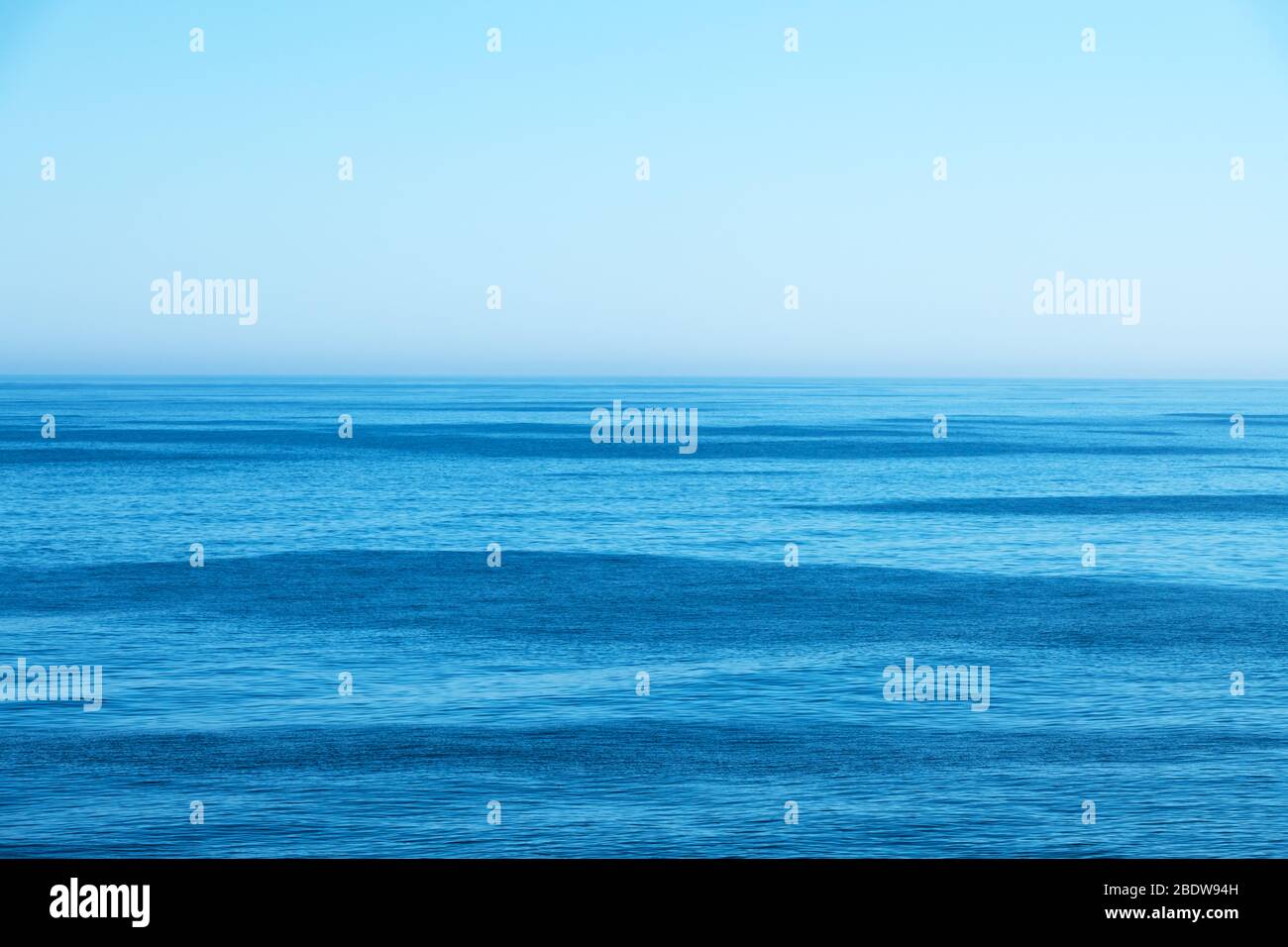 Ocean water and blue sky abstract background. Sea water texture closeup Stock Photo