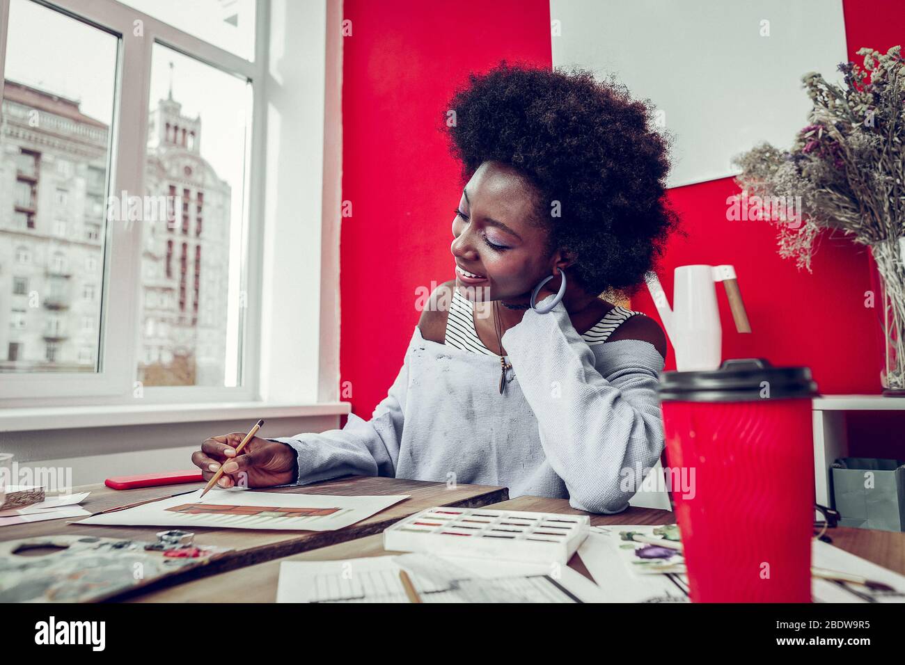 Dreamy young international artist drawing her sketch Stock Photo