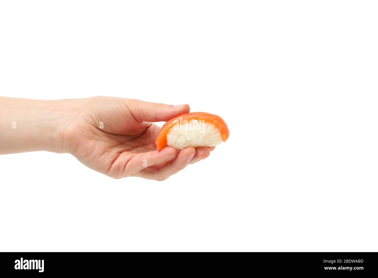 Female hand holds sushi roll, isolated on white background Stock Photo
