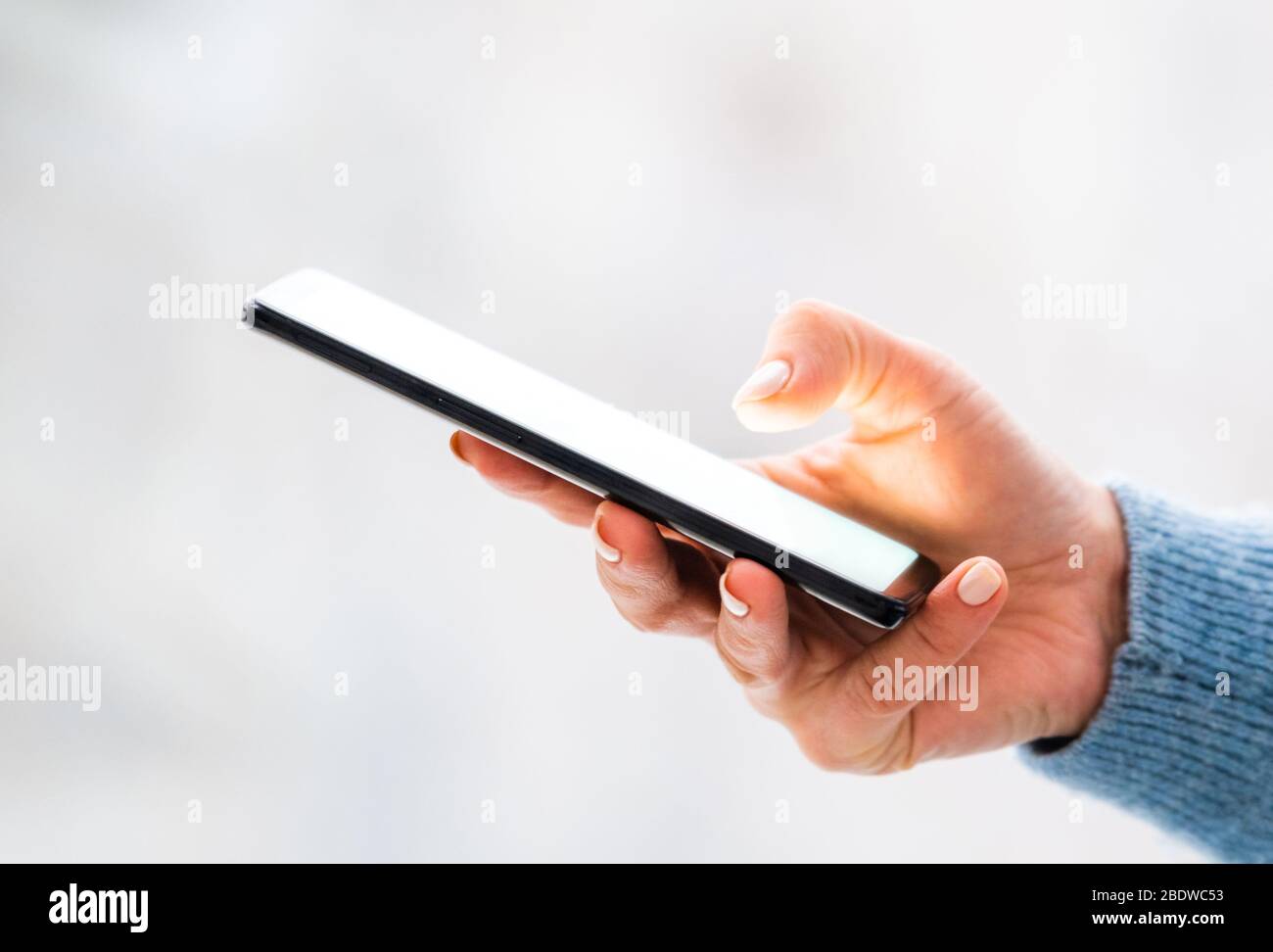 Beautiful hand holding mobile phone Stock Photo