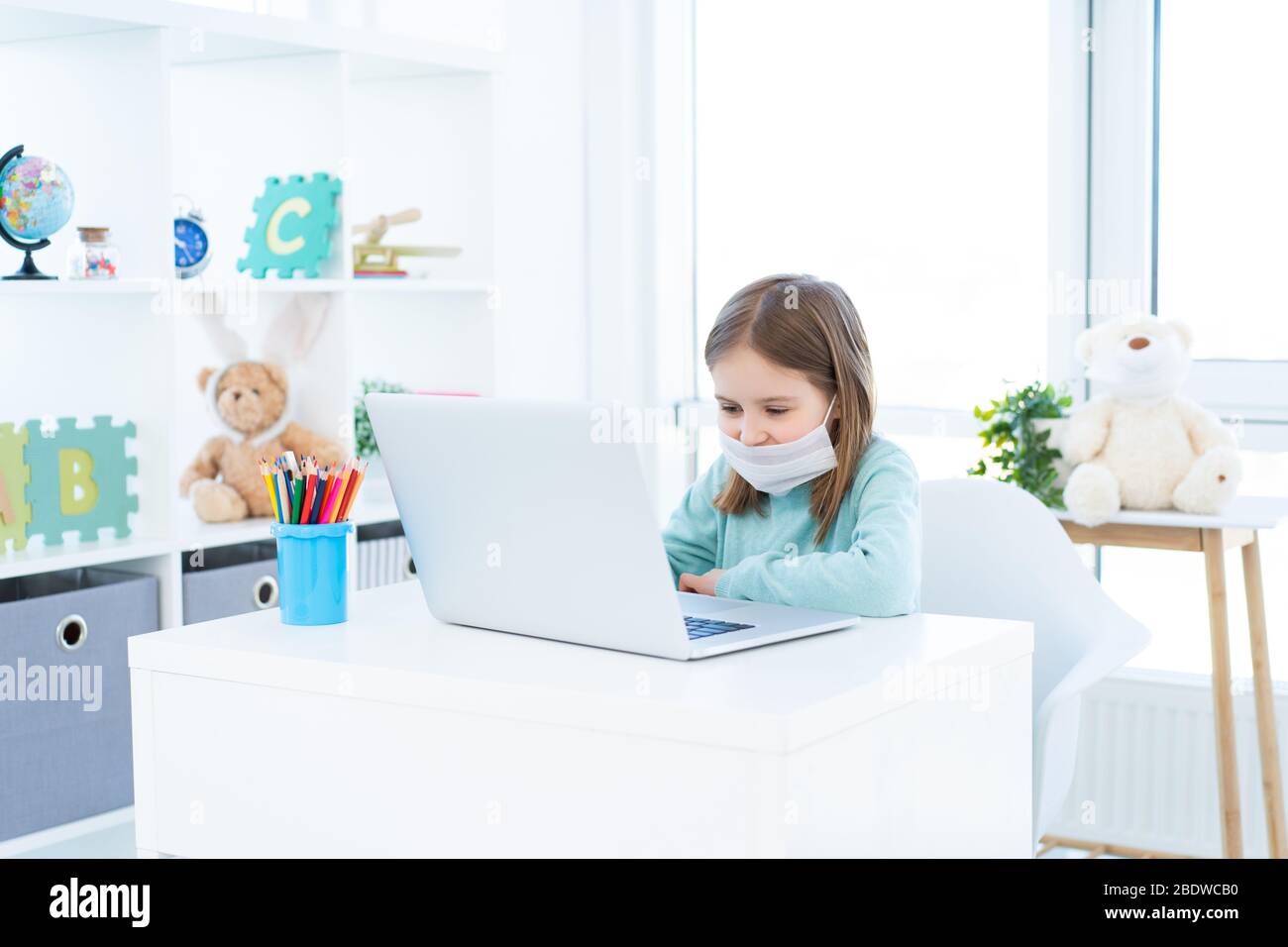 Cute little girl studying at home during quarantine Stock Photo - Alamy