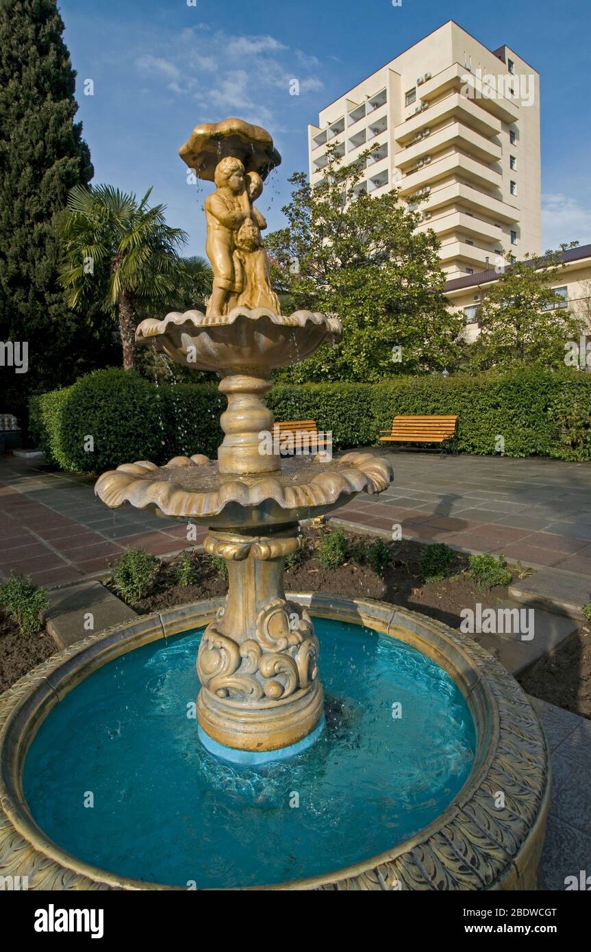 This is a general view of Alushta resort situated in Crimea. The fountain with figures of relax people is in the foreground. Stock Photo