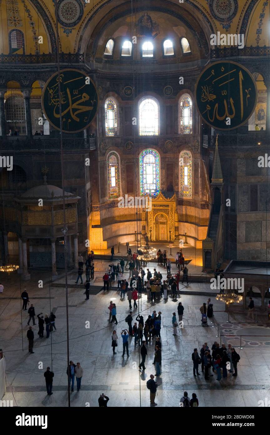 Turkish and foreign tourists in the south aisle of the famous former basilica and mosque, Hagia Sofia, in the Sultanahmet district of Istanbul. It is Stock Photo