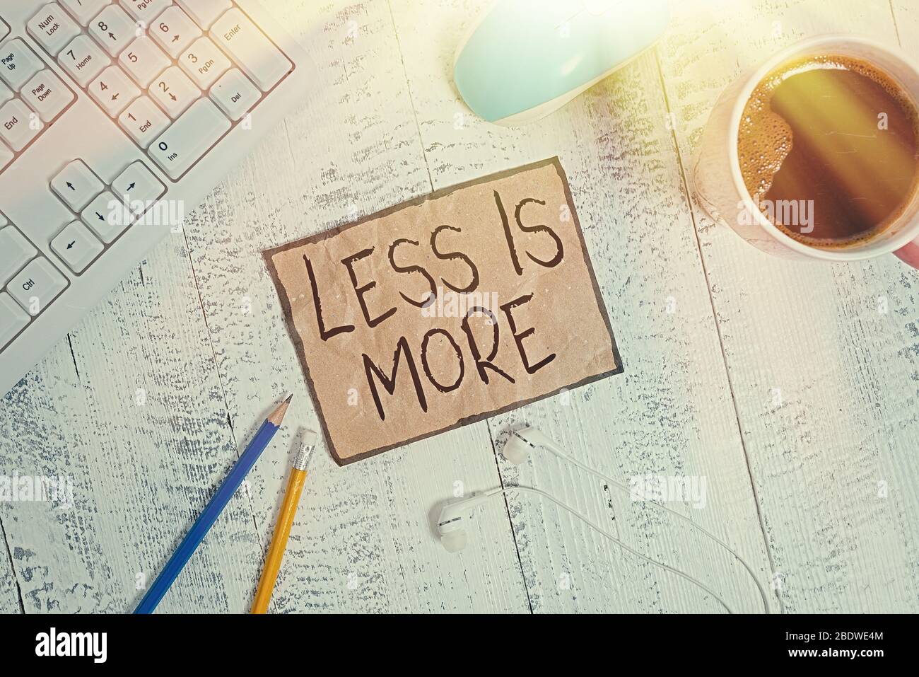 Writing note showing Less Is More. Business concept for used to express ...