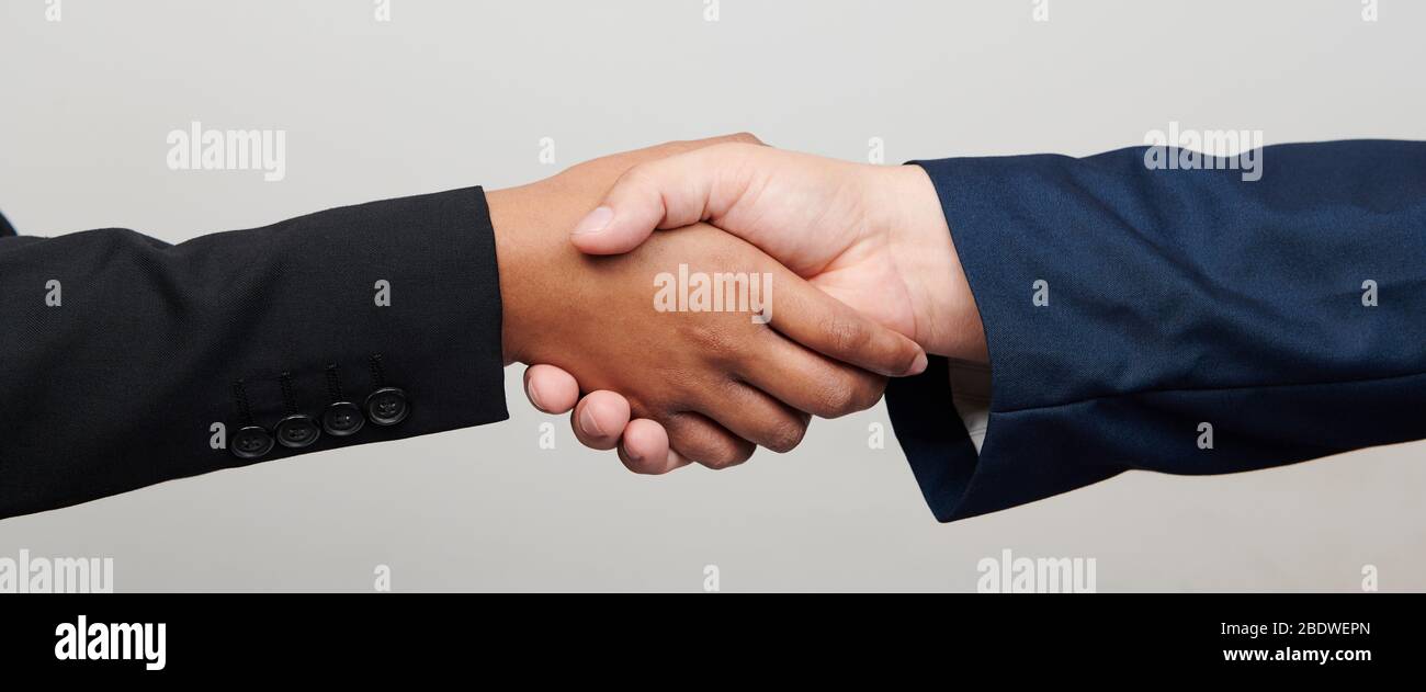Handshake of woman and men isolated close up view Stock Photo