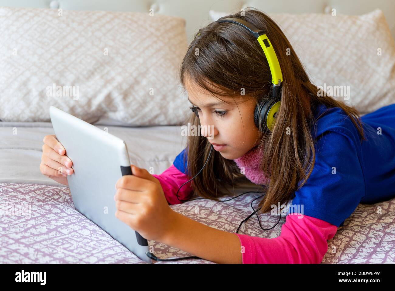 Preteen girl lying on bed hi-res stock photography and images - Alamy