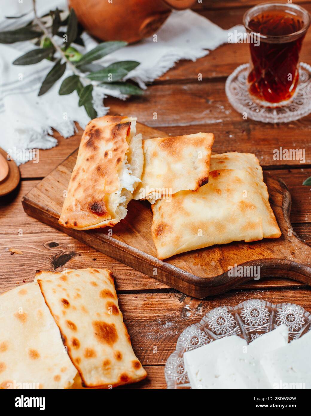 crepes with cheese on wooden board Stock Photo