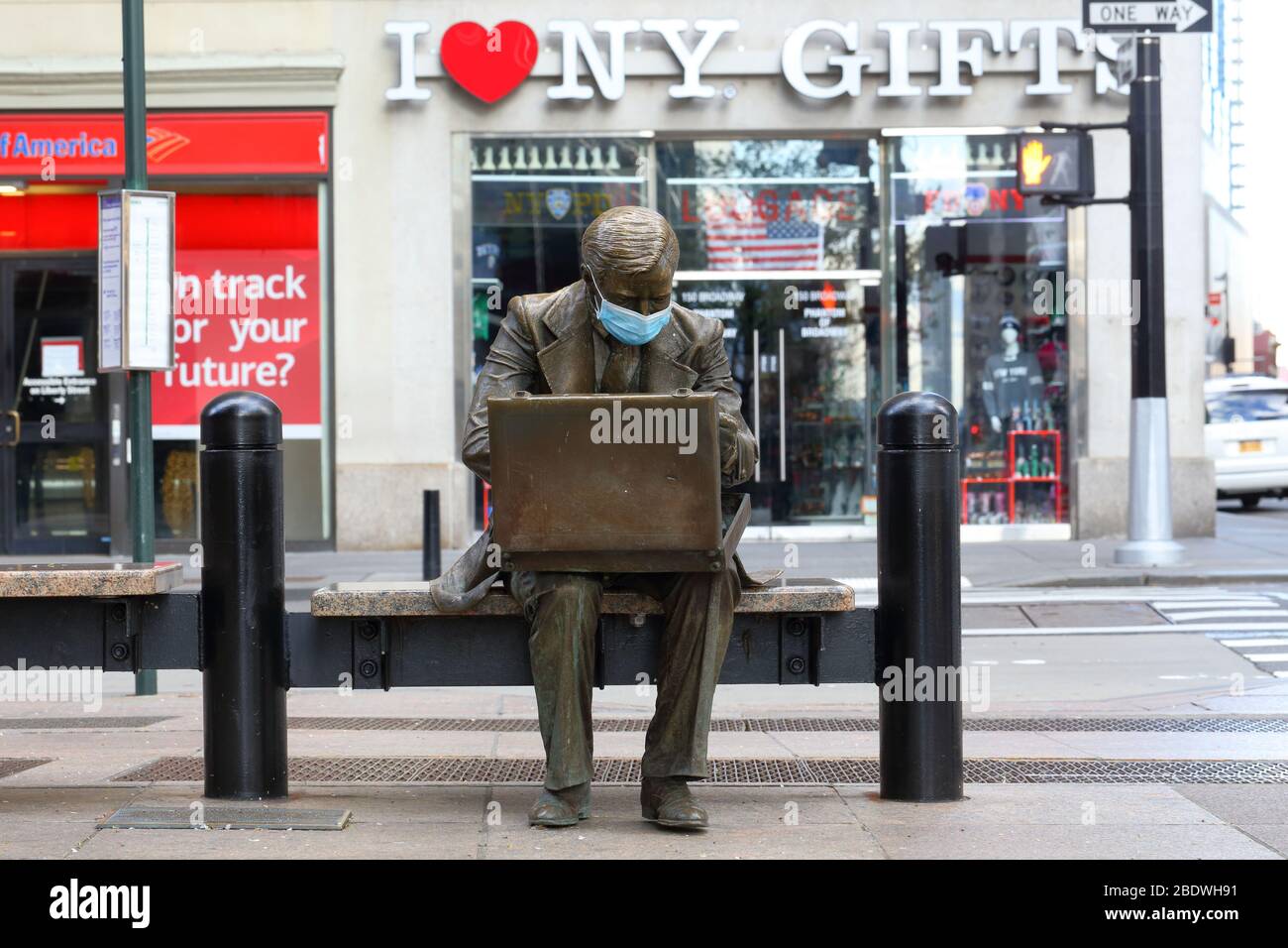 The 'Double Check' businessman statue with a face mask as a symbol of the current coronavirus COVID-19 pandemic in New York, NY. Stock Photo