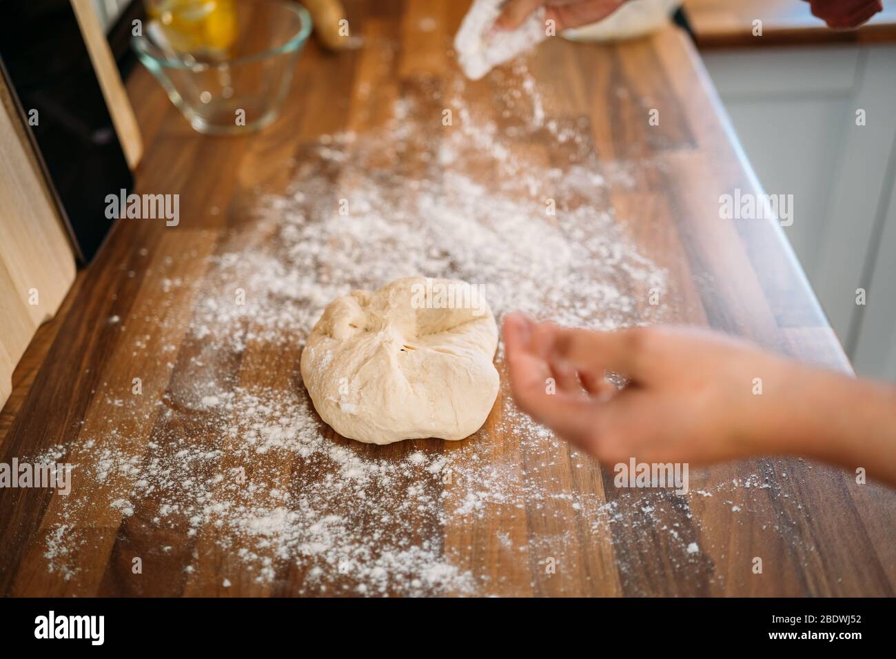 Woman kneading the dough to make a pizza in her home kitchen Stock ...