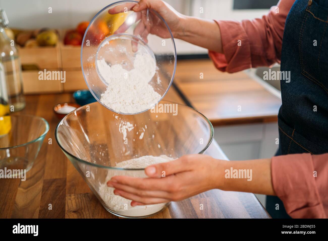 Girl mixing a bowl of pizza dough - Stock Image - C054/2481