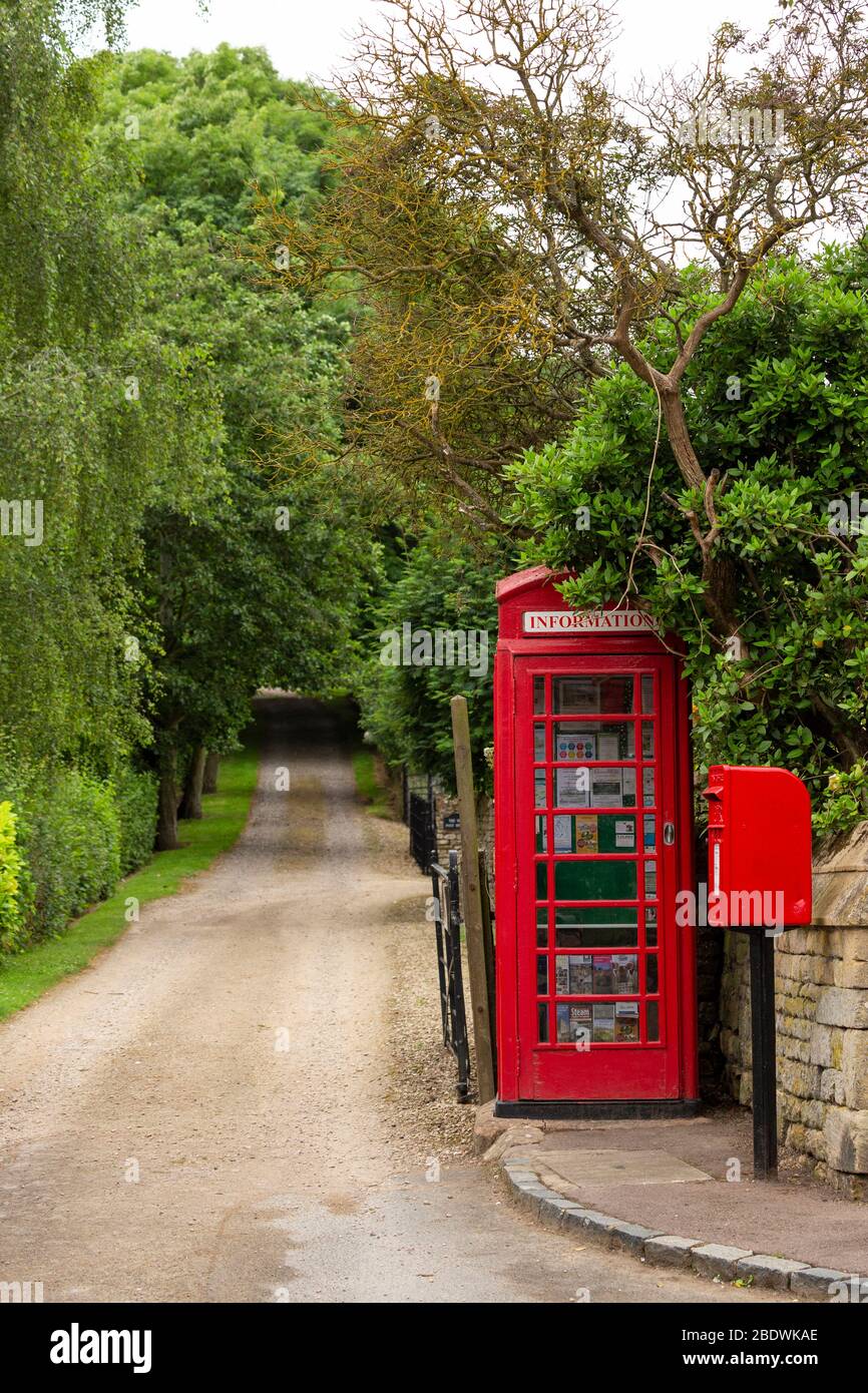 Red public telephone booth and postbox at The Old Post House in the village of Stanton, Cotswolds, England Stock Photo