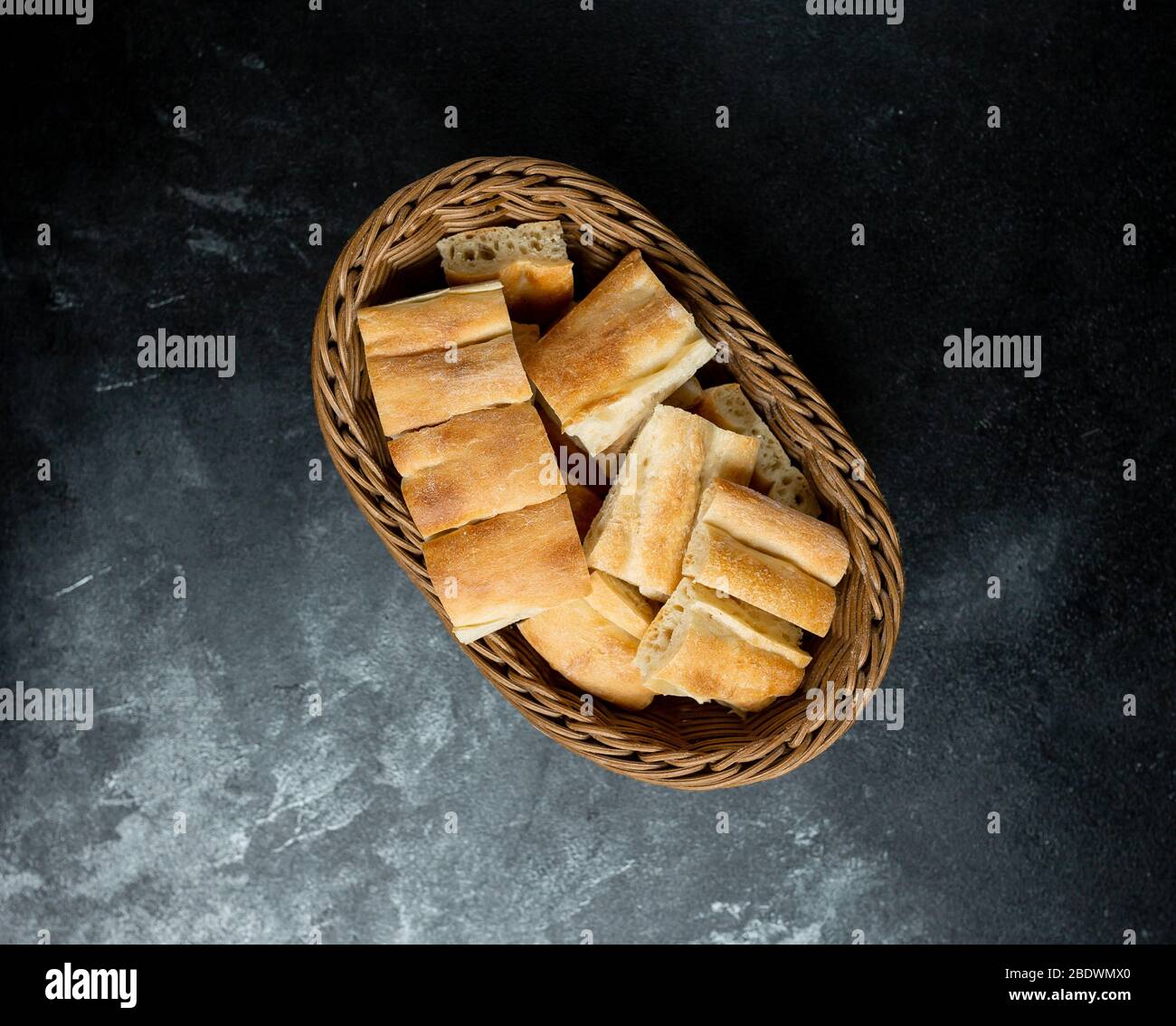 wicker basket with tendering bread on the table Stock Photo