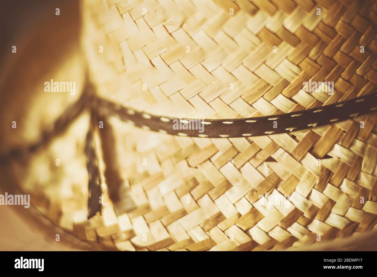 A nice old straw hat with a dark ribbon tied in a bow, which is ...