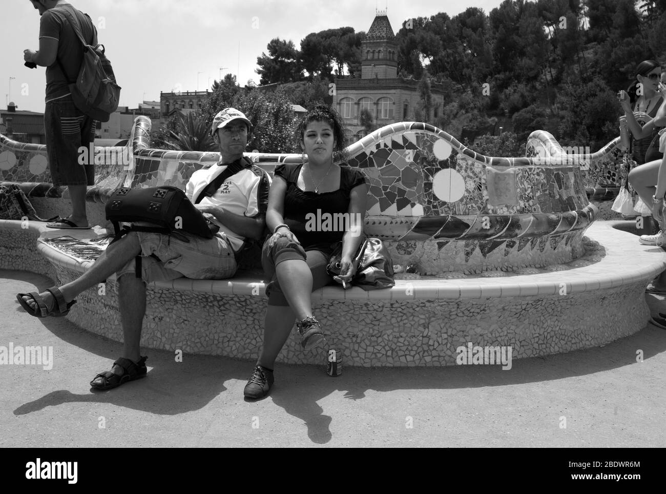 Tourists on curved seat, Park Guell, Barcelona Stock Photo