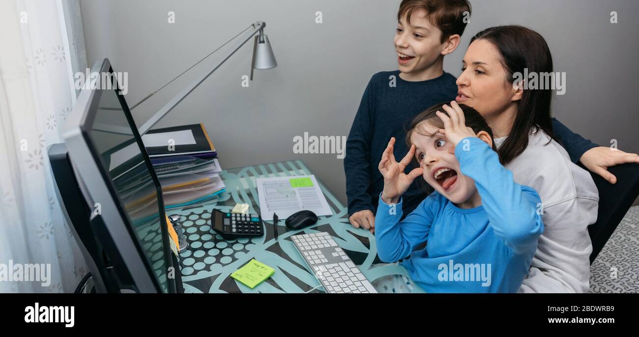 Family talking on video call while the girl grimaces Stock Photo