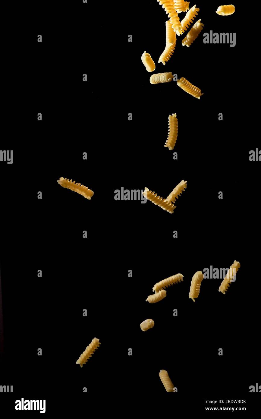 Download Falling Fusilli Pasta Flying Yellow Raw Macaroni Over Black Background Stock Photo Alamy Yellowimages Mockups