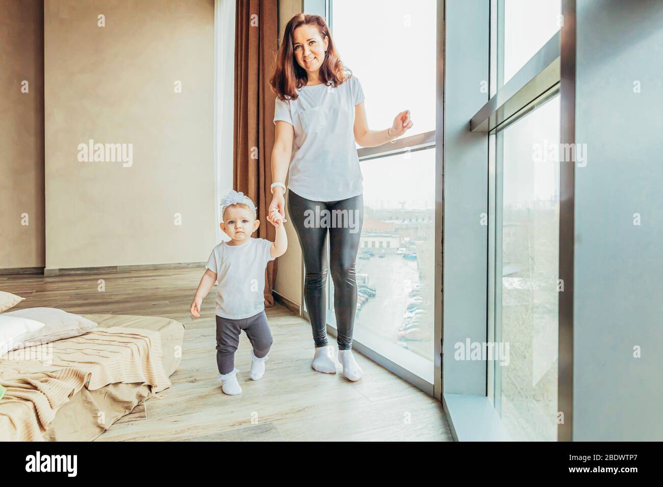 Stay Home Stay Safe. Young mother holding her child. Woman and infant