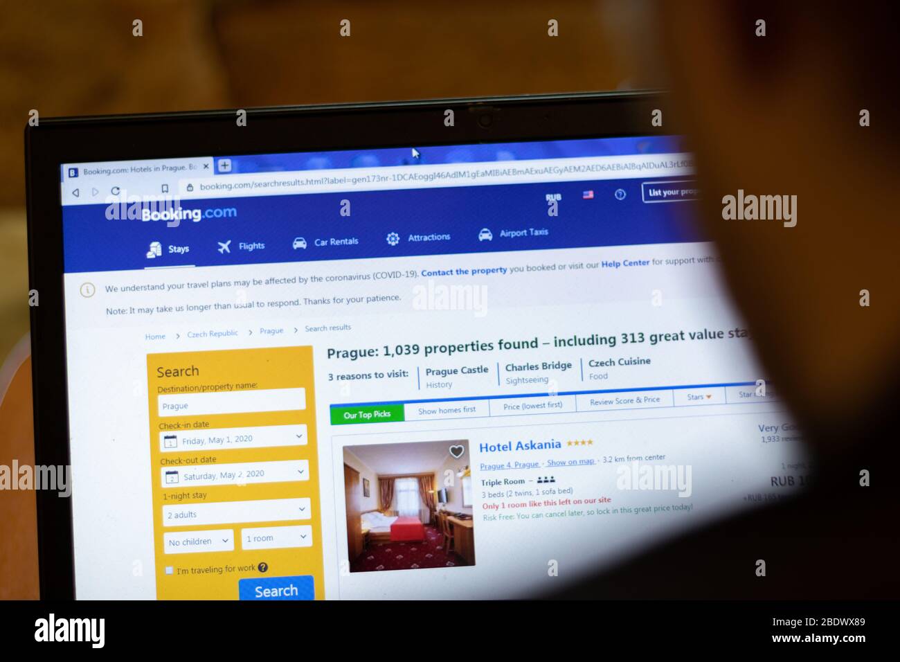 New York, USA - 9 April 2020: Booking website on laptop screen close up. Man using service on display, blurry background, Illustrative Editorial Stock Photo