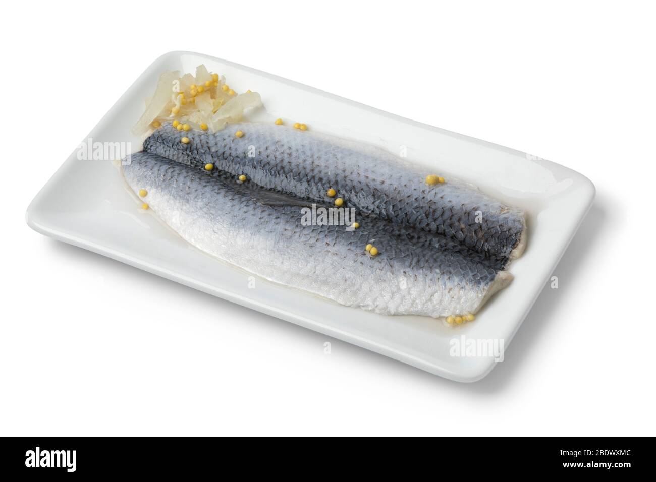 Traditional Dutch pickled herring with onions and mustard seed on a