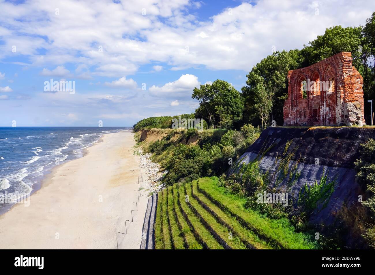 Aerial view of beautiful beach, sea and ruins of church in Trzesacz, Poland. Bright sunny day. Empty and closed due to covid 19 or coronavirus Stock Photo