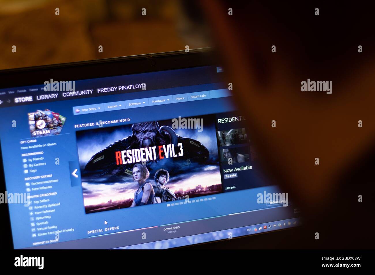 New York, USA - 9 April 2020: Steam game store application on laptop screen close up. Man using service on display, blurry background, Illustrative Stock Photo
