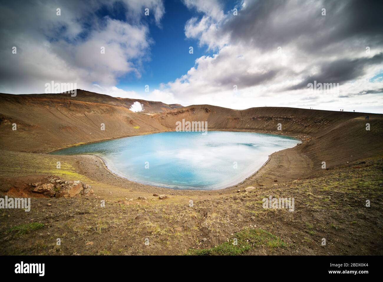 The Mouth Of A Volcano Crater Filled With Water In Iceland. Water Lake 