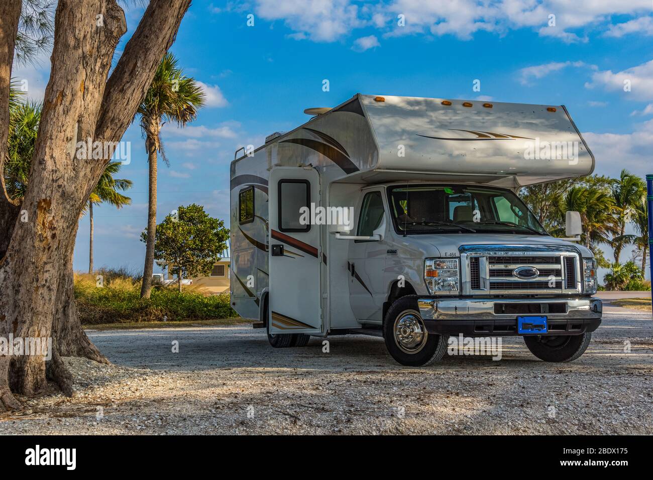 C-type camper standing on a beach in the sand Stock Photo