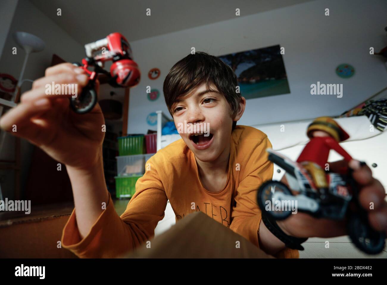 Boy playing with toys whilst confined to home during Covid19 lockdown in Catalonia, Spain Stock Photo