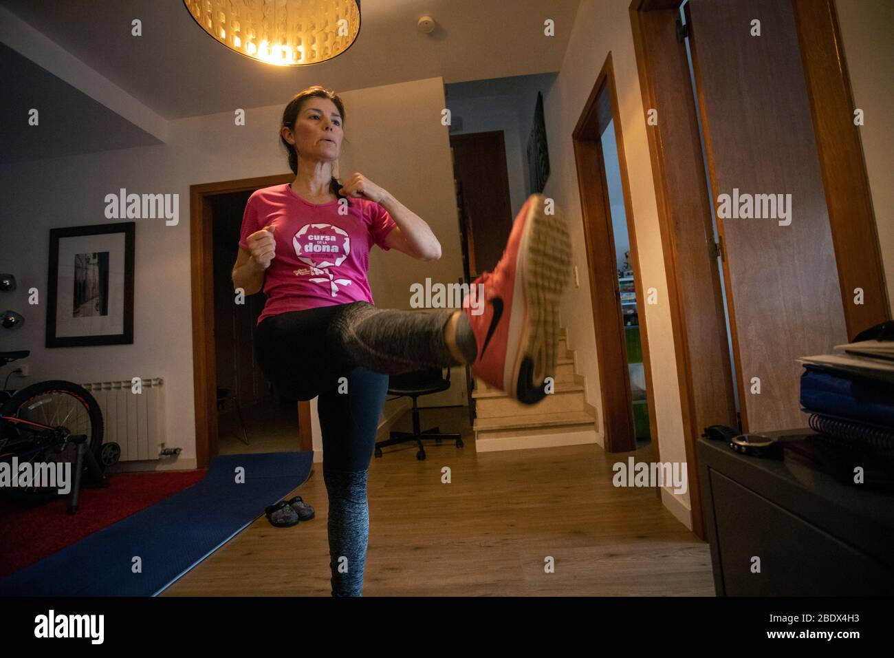 Woman doing exercise in a Spanish home during Covid19 confinement in Girona, Catalonia, Spain Stock Photo