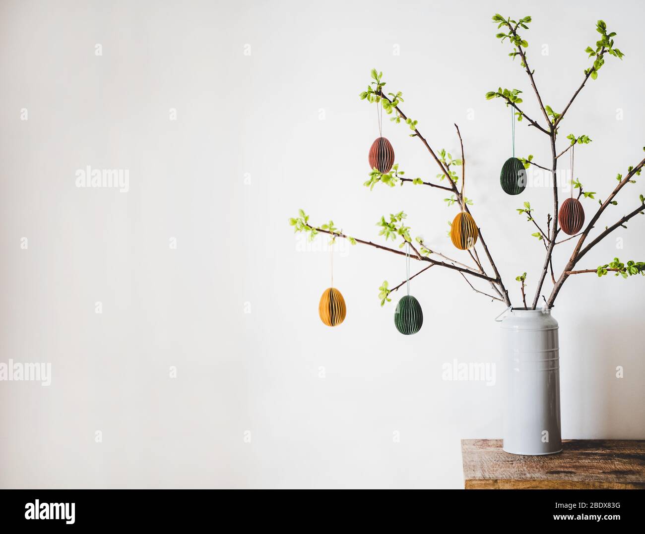 Easter holiday tree branches with festive eggs, copy space Stock Photo