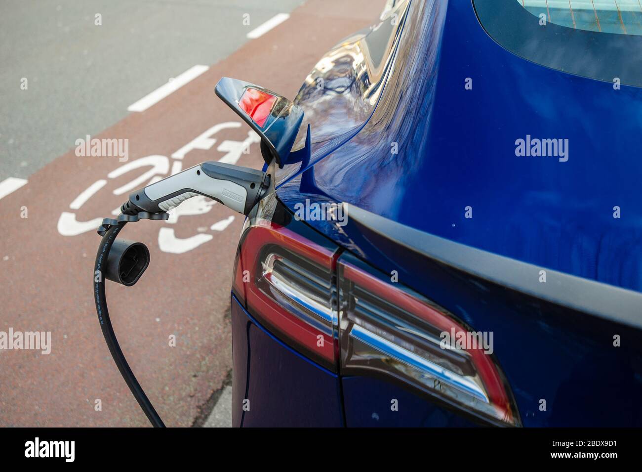 Electric vehicle charging station. TESLA Model S on charge. The Hague
