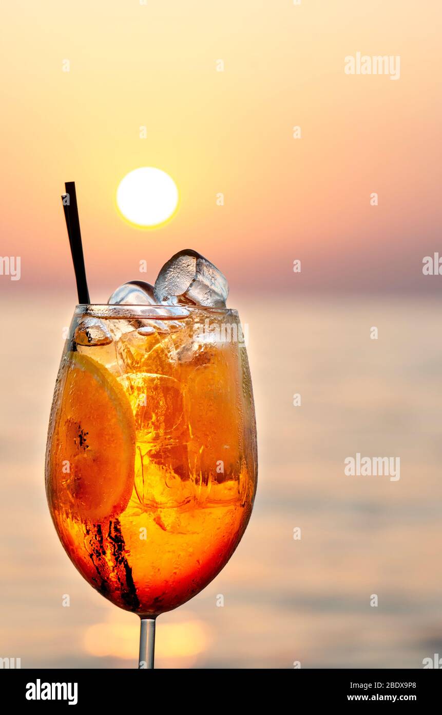 Aperol Spritz Cocktail on the beach with sunset Stock Photo - Alamy