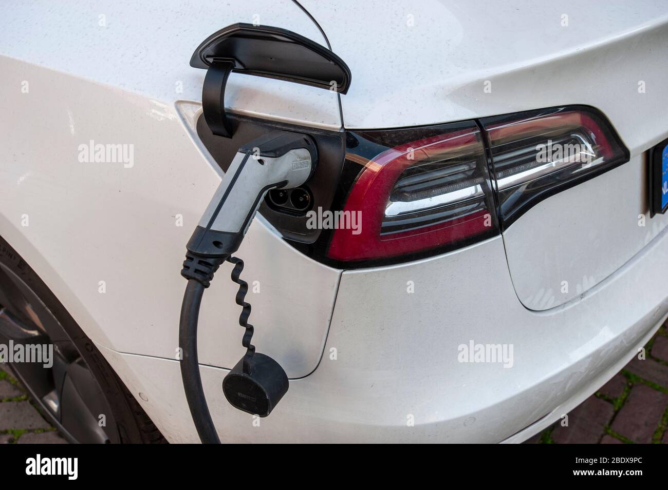 Electric vehicle charging station. TESLA Model S on charge. The Hague