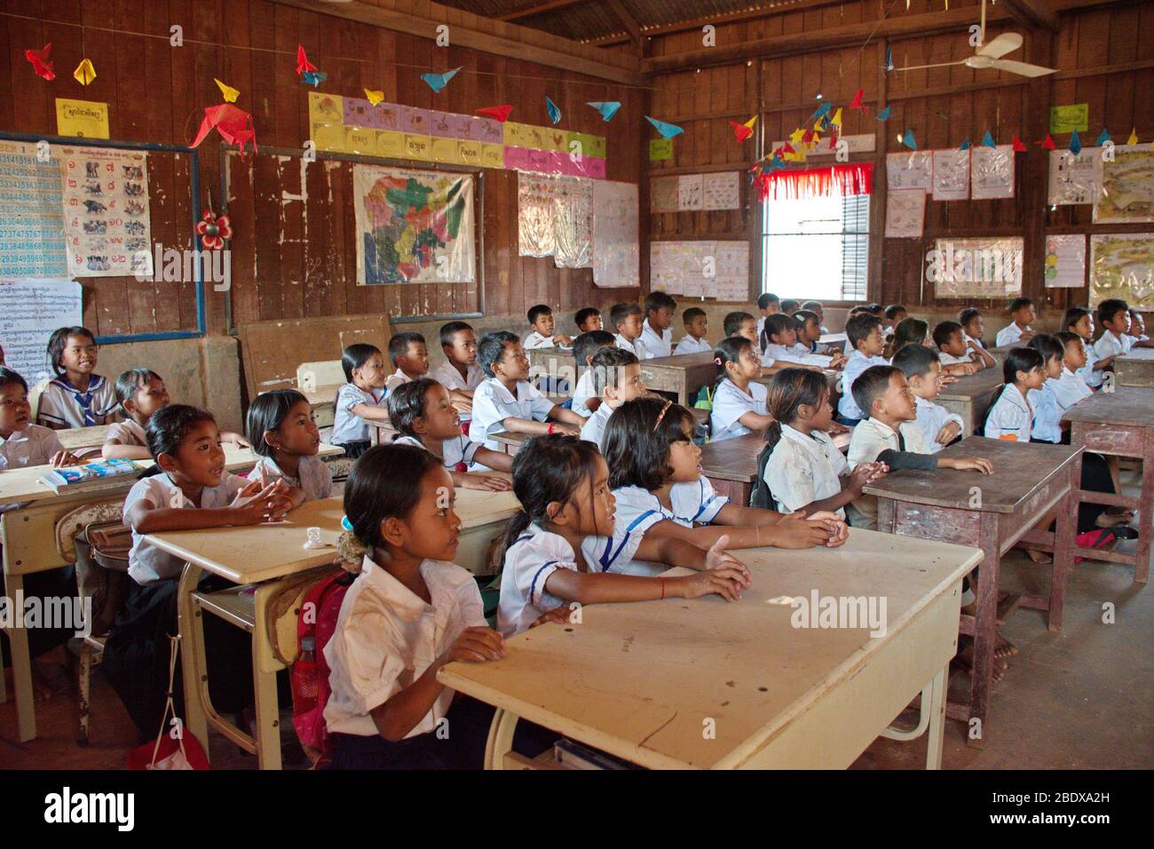 Pupils sitting in schools benches Stock Photo - Alamy