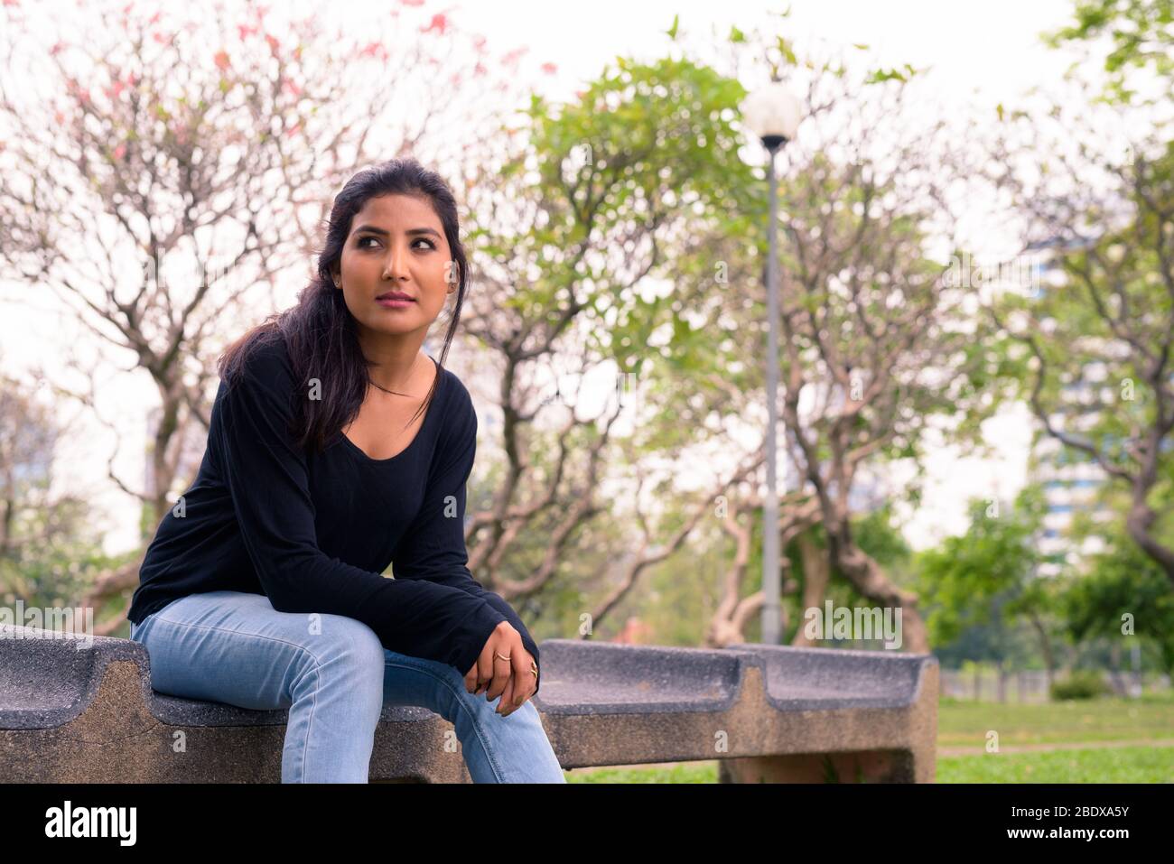 Young beautiful Persian woman thinking at the park Stock Photo