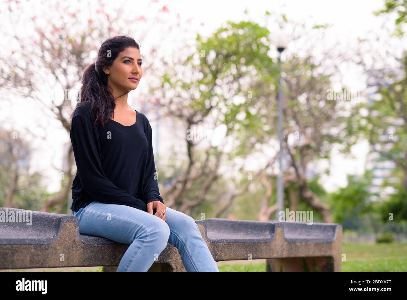 Young beautiful Persian woman relaxing at the park Stock Photo