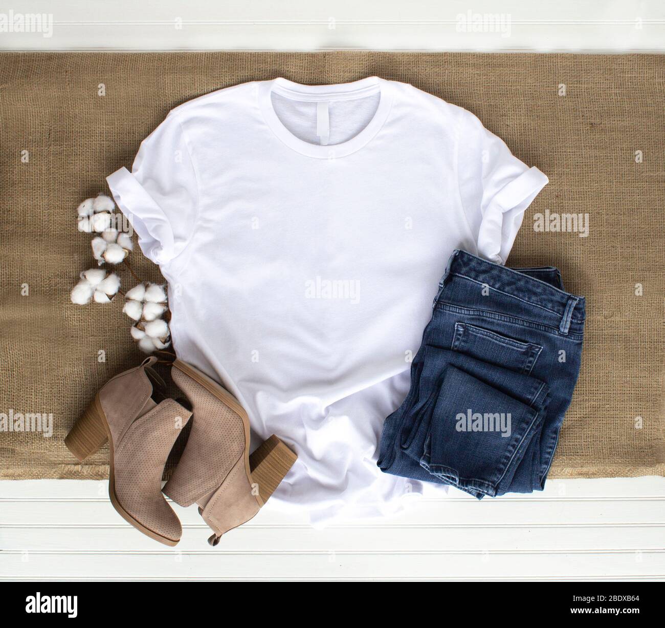 White shirt mockup - tshirt with cotton balls, burlap, boots & jeans Stock Photo