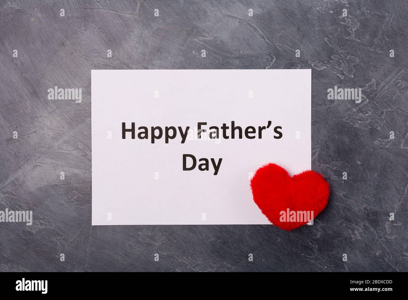 Happy Father's Day text on grey background with red heart. Free space. Space for text. Father's day holiday concept.  Stock Photo