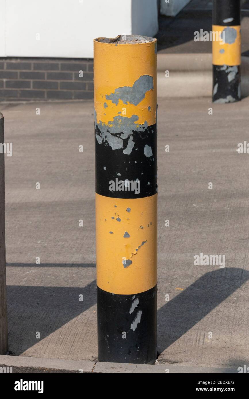 a close up view of a yellow and black caution steel pole for a loading